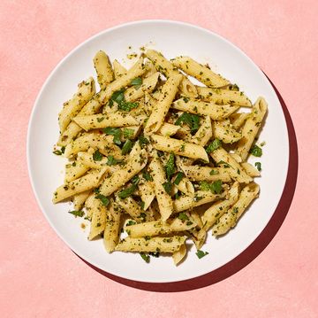 pasta with herbs on a pink background