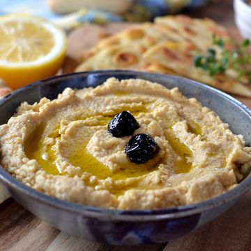 close up of hummus in bowl on table