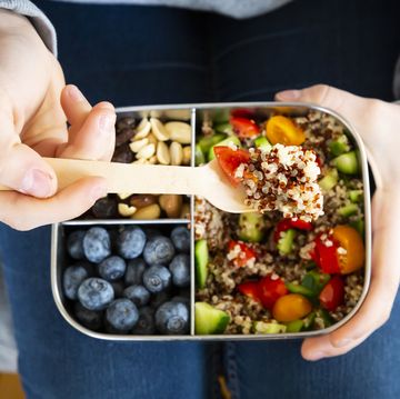 lunchbox with quinoa salad with tomato and cucumber, blue berry and trail mix