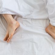 problems in family relationship feet of man and woman in white bed at distance